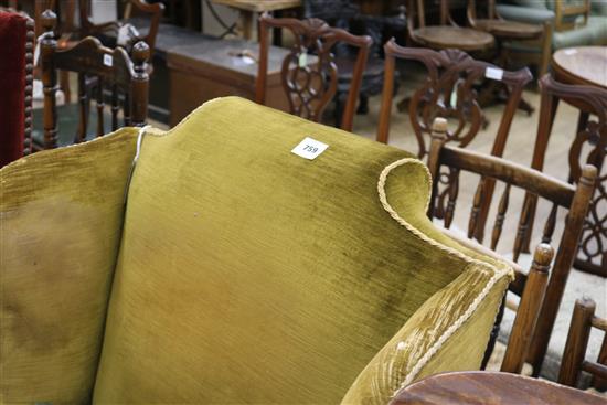 A Georgian style wing back armchair with gold upholstery